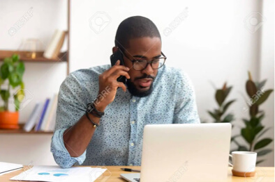 Man calling using a phone and a laptop